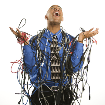 IT Support small business Man wrapped in cables.